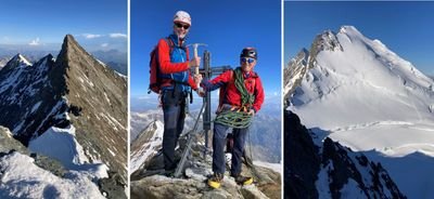 Two people with helmets and climbing gear are standing on a snow-covered mountain peak.