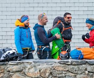 Mountaineers pack their backpacks at the mountain hut.