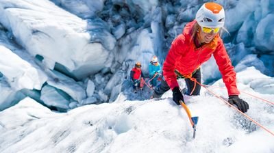Mountaineer climbing with ice axe