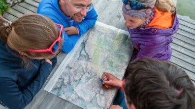 People planning their tour on a map
