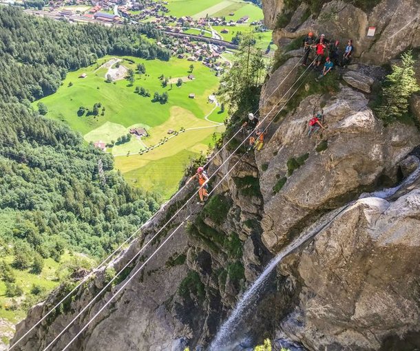 People on a rope bridge on the via ferrata Allmenalp